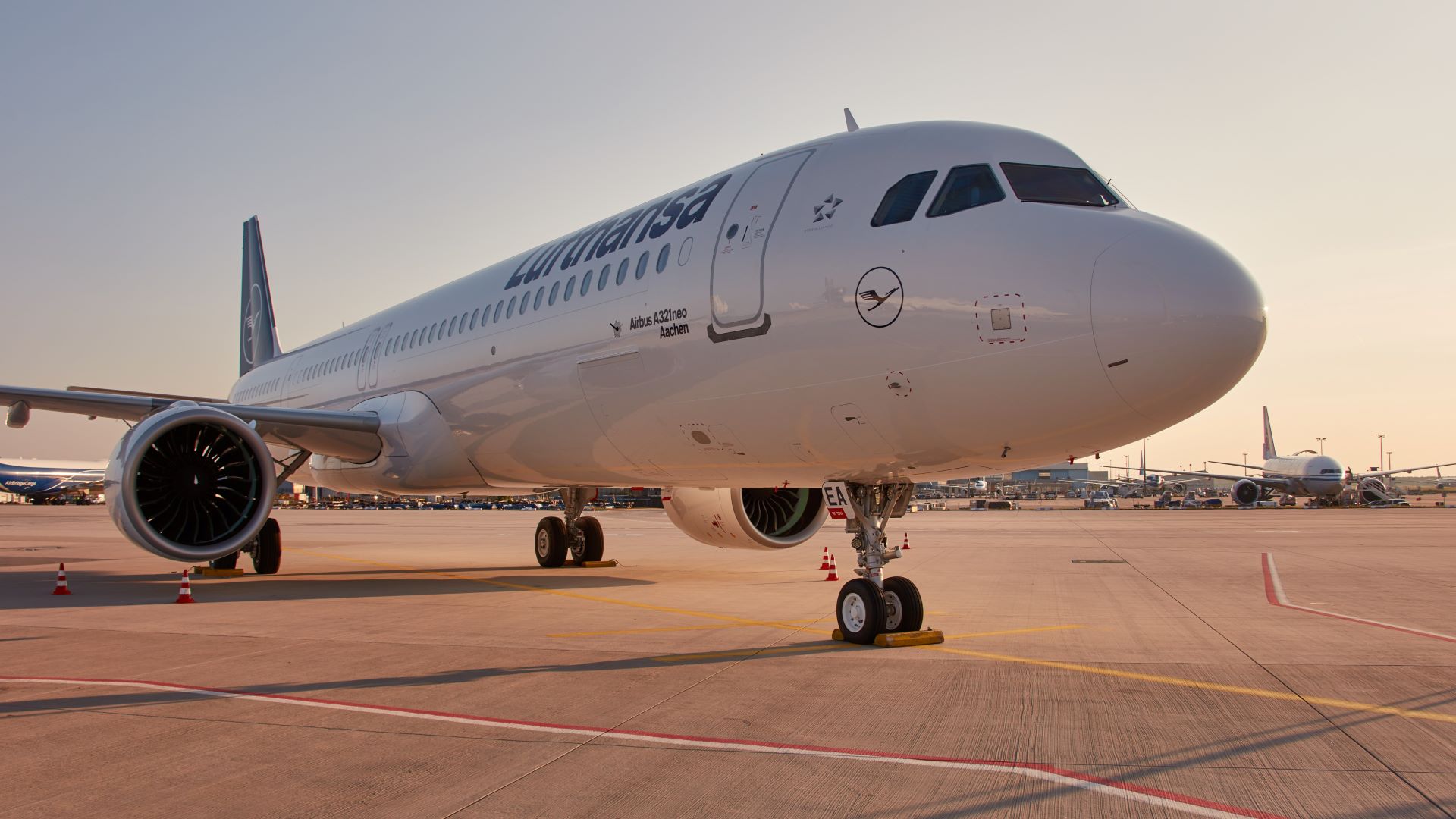 Close up front view of a white Lufthansa jet.