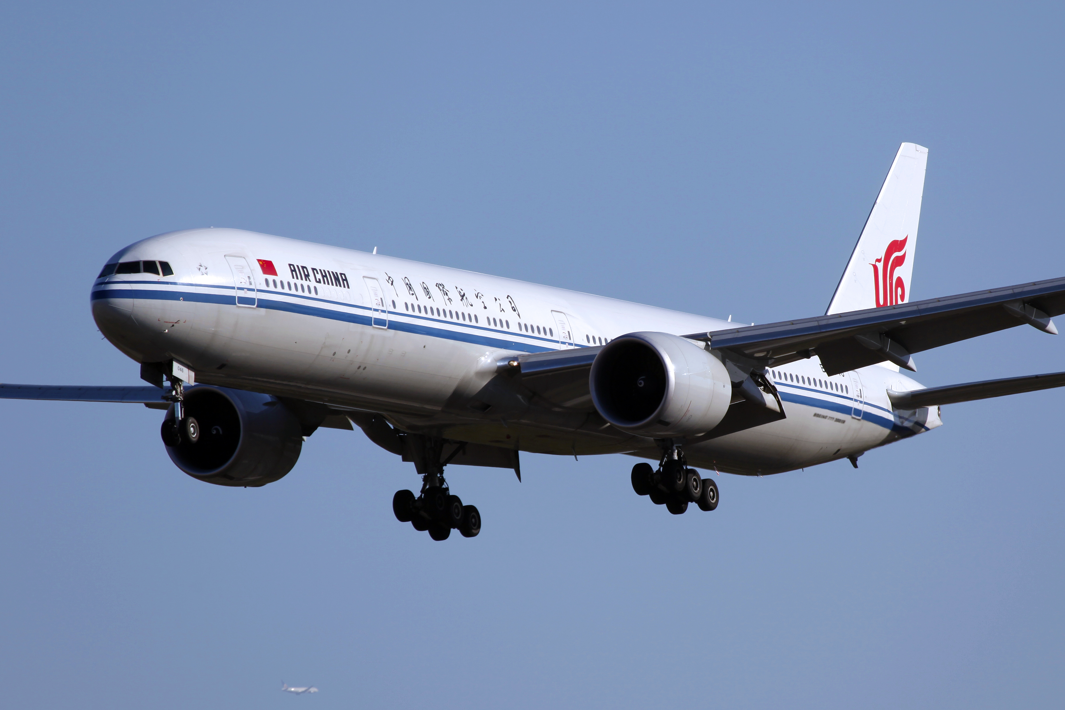 A large Air China jet comes in for a landing with wheels down. The airline is canceling many flights because of COVID restrictions in Shanghai.