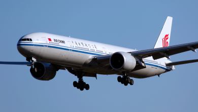 A large Air China jet comes in for a landing with wheels down. The airline is canceling many flights because of COVID restrictions in Shanghai.