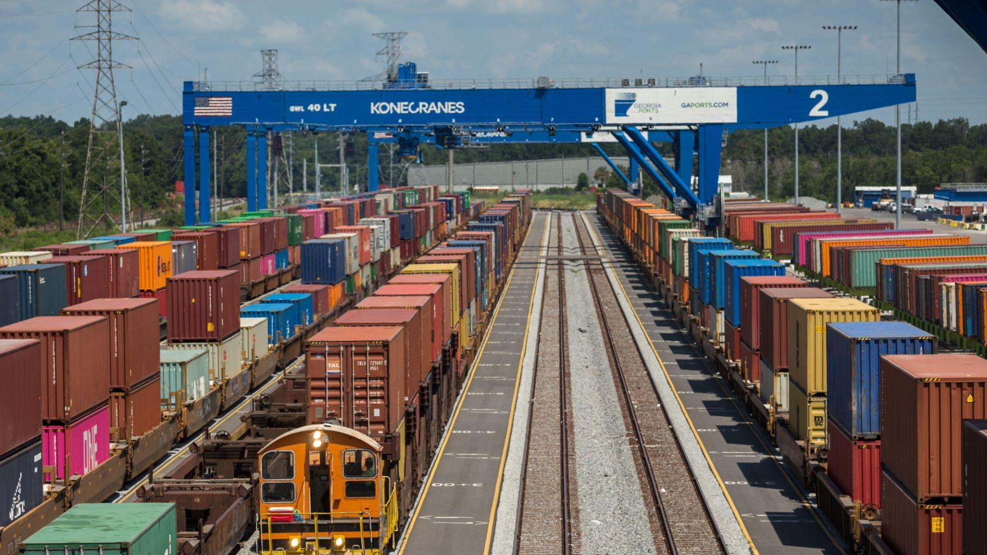 A giant blue crane straddles rail tracks with intermodal container trains. at the Port of Savannah. Konecranes makes the equipment and just abandoned its merger with Cargotec because it couldn't get regulatory approval.