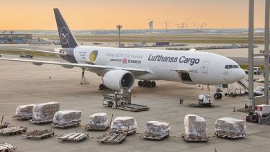 A Lufthansa Cargo jet with containers waiting on the tarmac for loading.