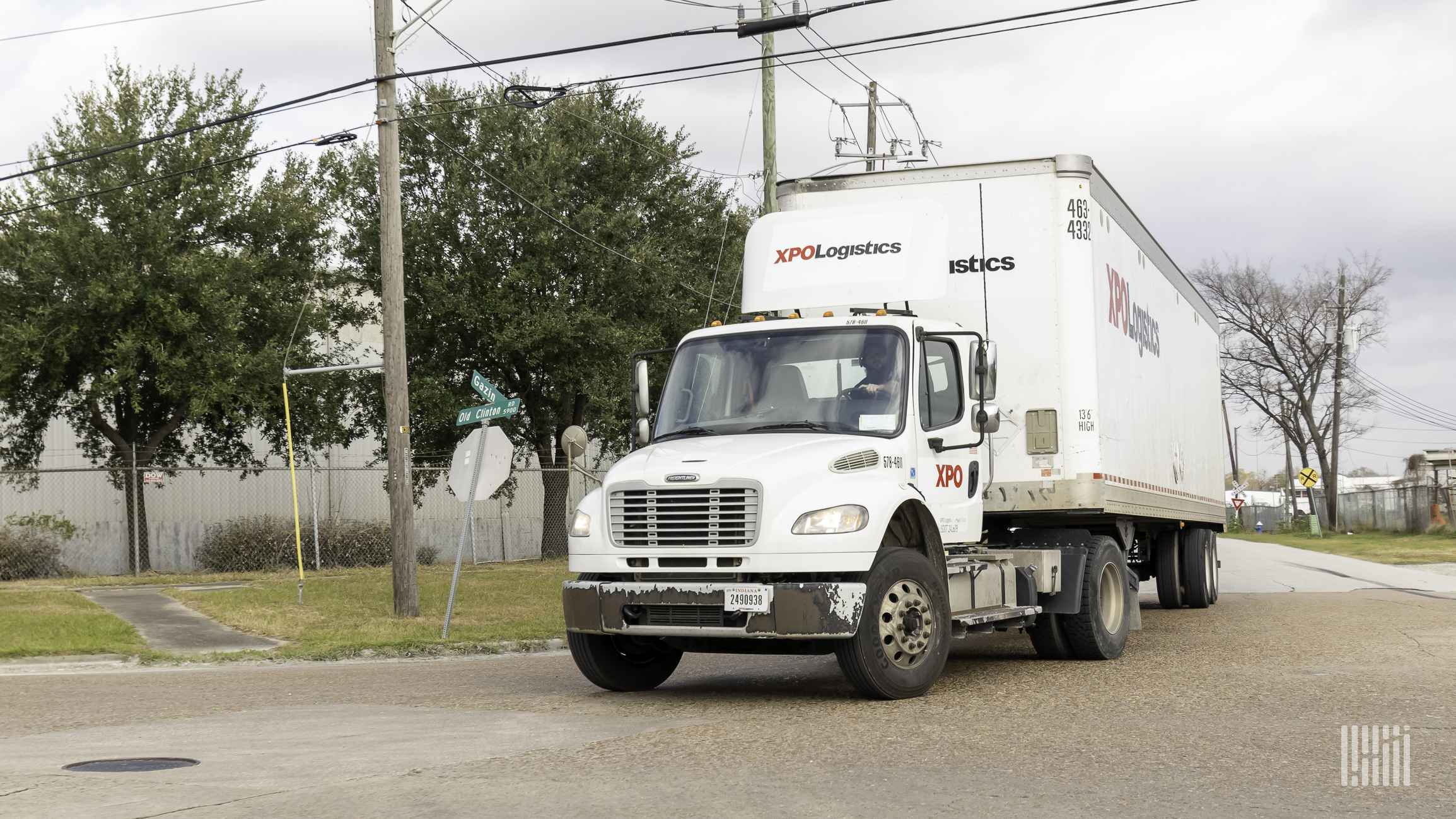 A white tractor-trailer with the logo of XPO Logistics