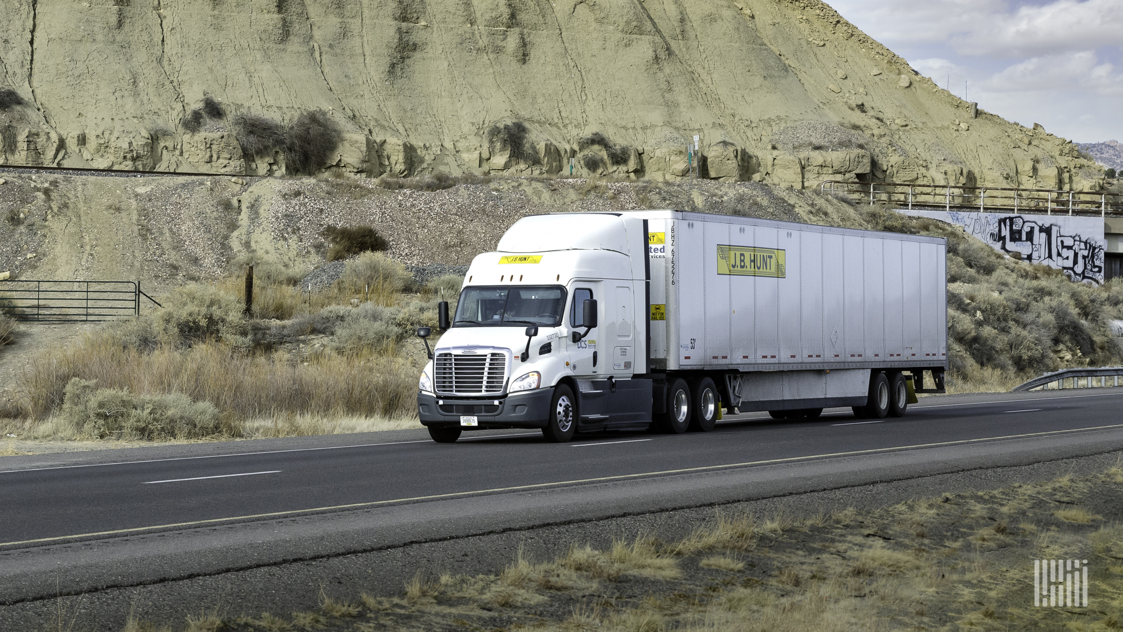 A white J.B. Hunt tractor-trailer on highway