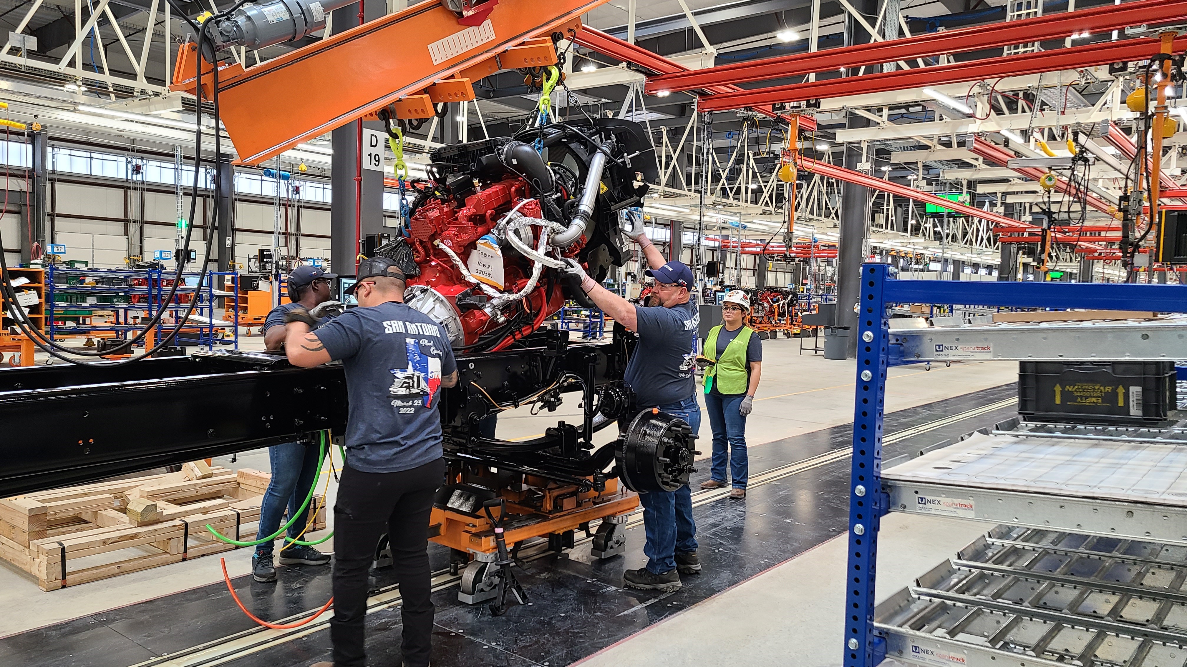 Workers mate an egine to a chassis at Navistar plant in San Antonio