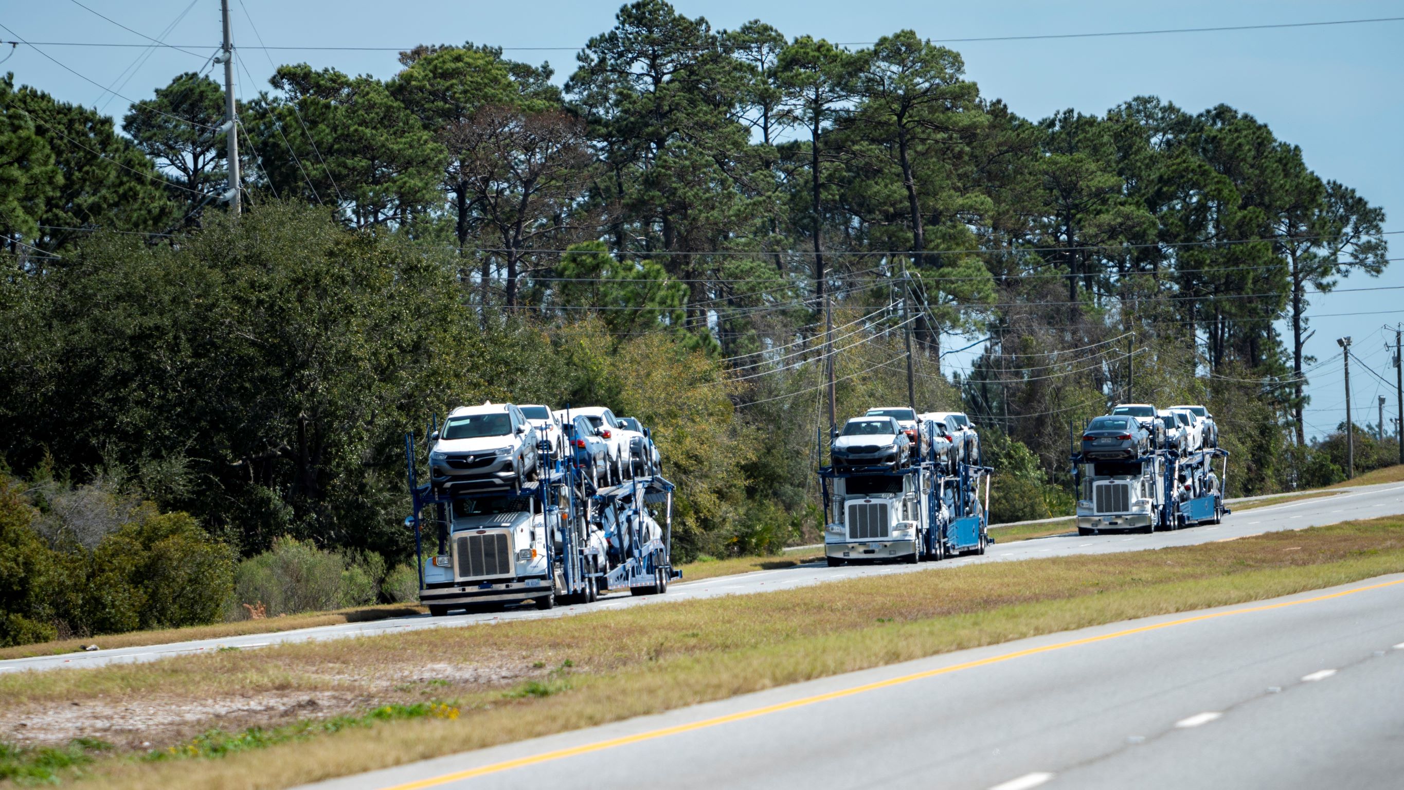 Three United Road car haulers on the highway