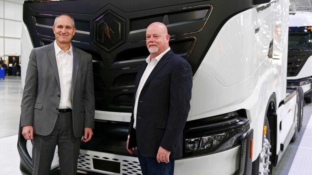 Nikola CEO Mark Russell and Mark Duchesne, head of global manufacturing, with one of the company's electric trucks.