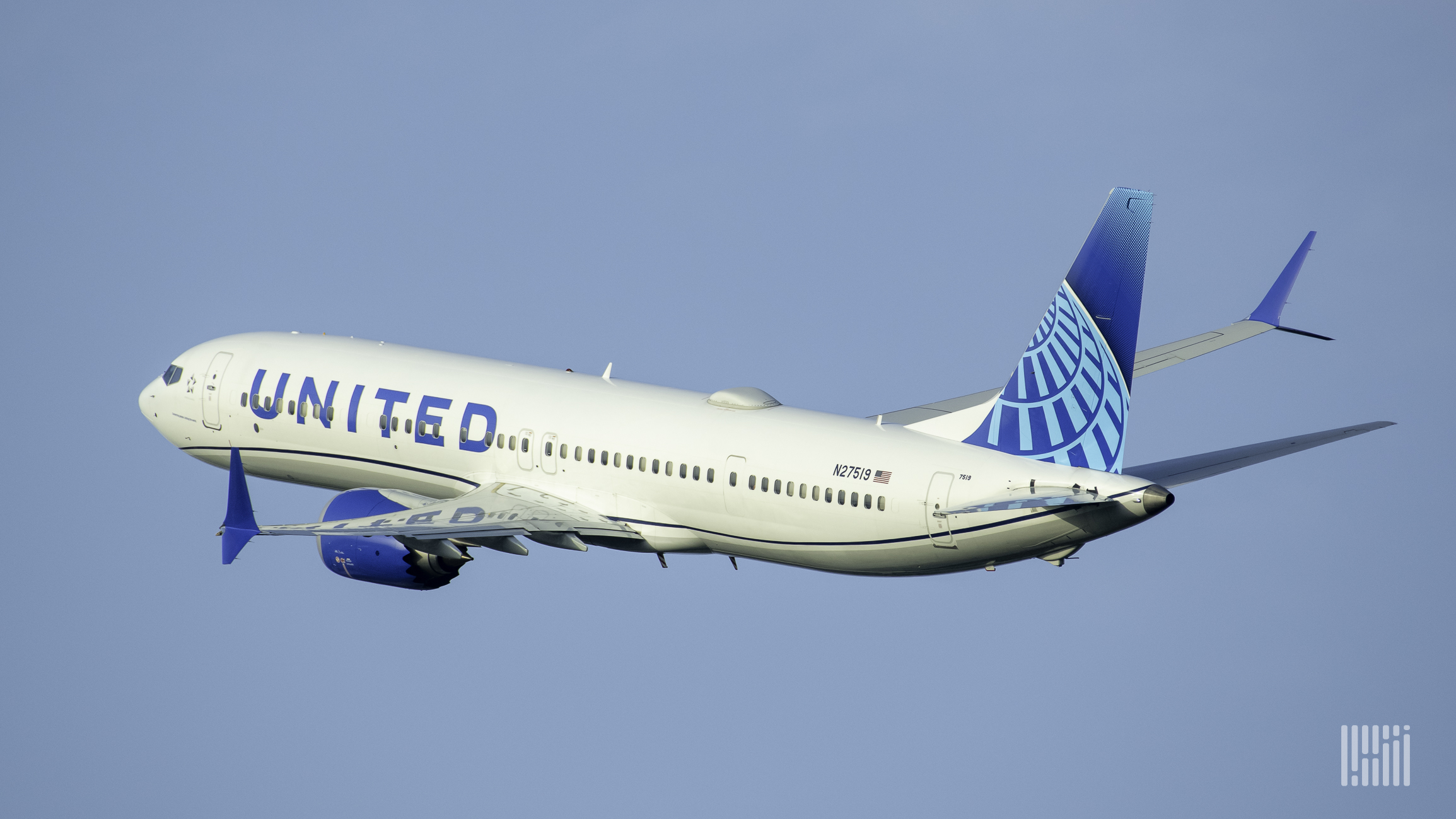 A white United Airlines jet with a blue tail flying into the blue sky heading away from the camera.