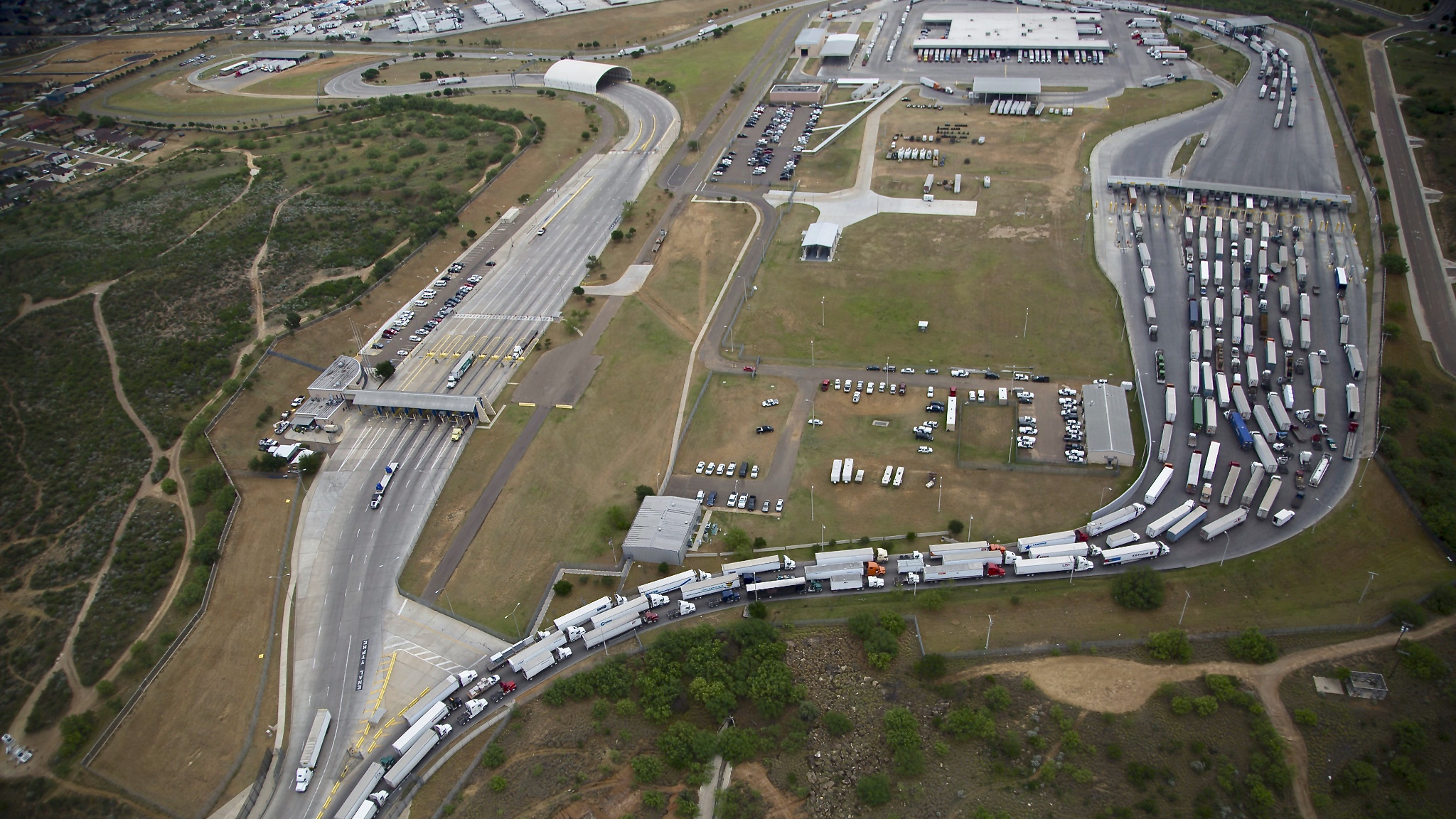 An aerial view of commercial trucks waiting to cross the US-Mexico border
