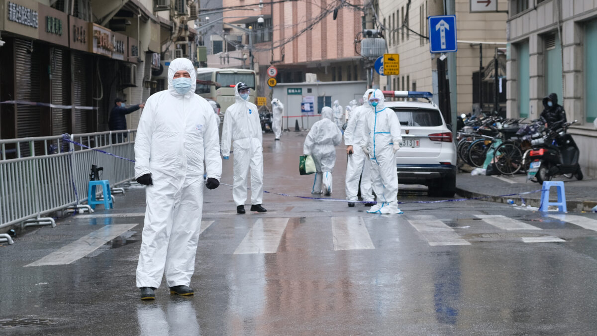 Medical staff in white hazmat suits on the streets of Shanghai. 