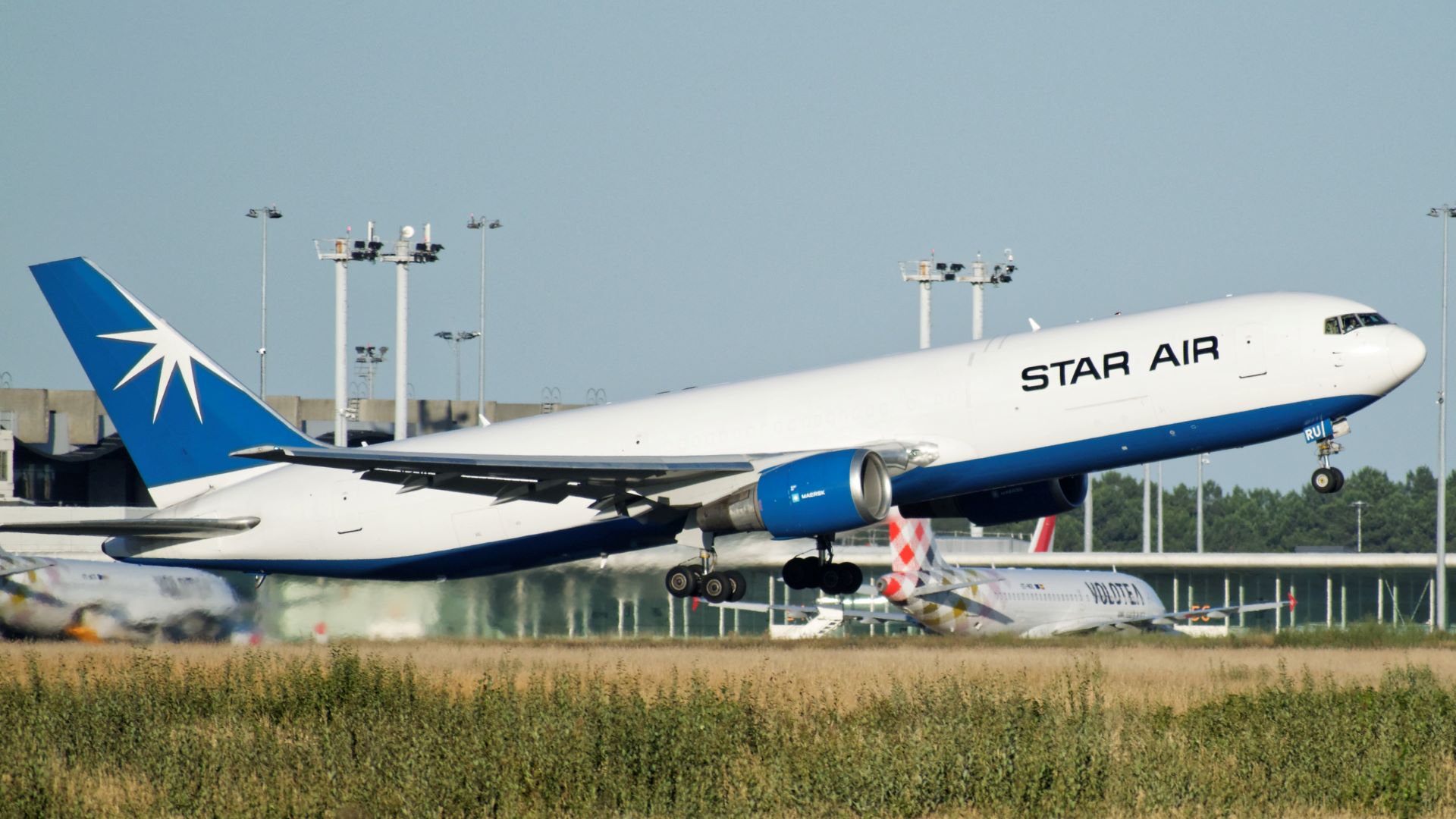 A Star Air jet, white with blue tail, lifts off the runway. Star Air is now fully integrated into Maersk's logistics operation.