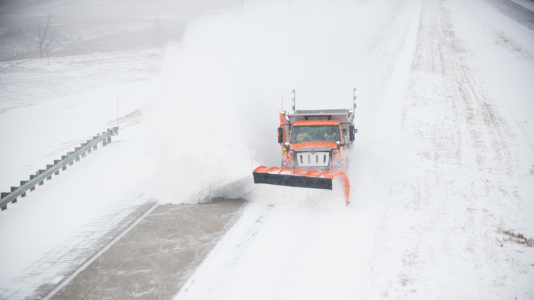 Plow clearing snow off North Dakota highway.