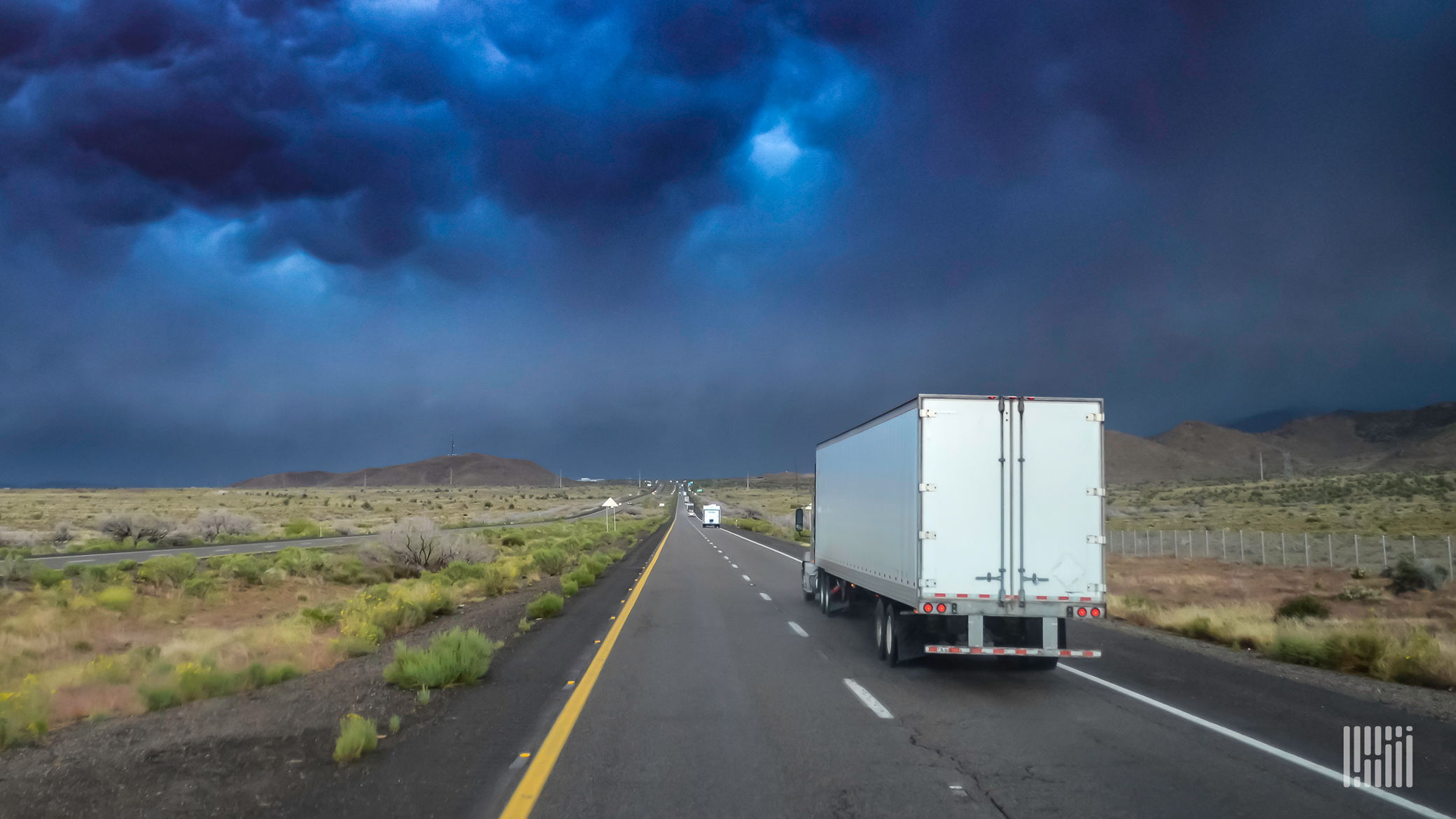 Truck heading toward a thunderstorm.