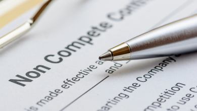 Blue pen and a the words non compete contract on a clipboard.