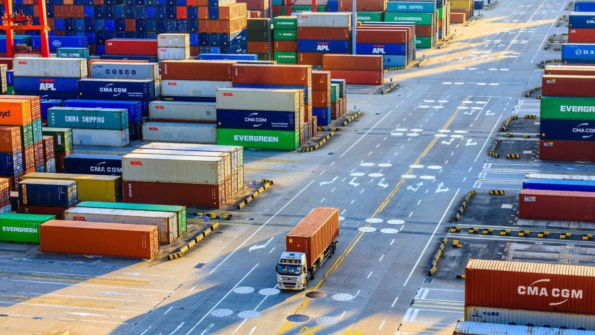 A truck pulls a container at the Port of Shanghai