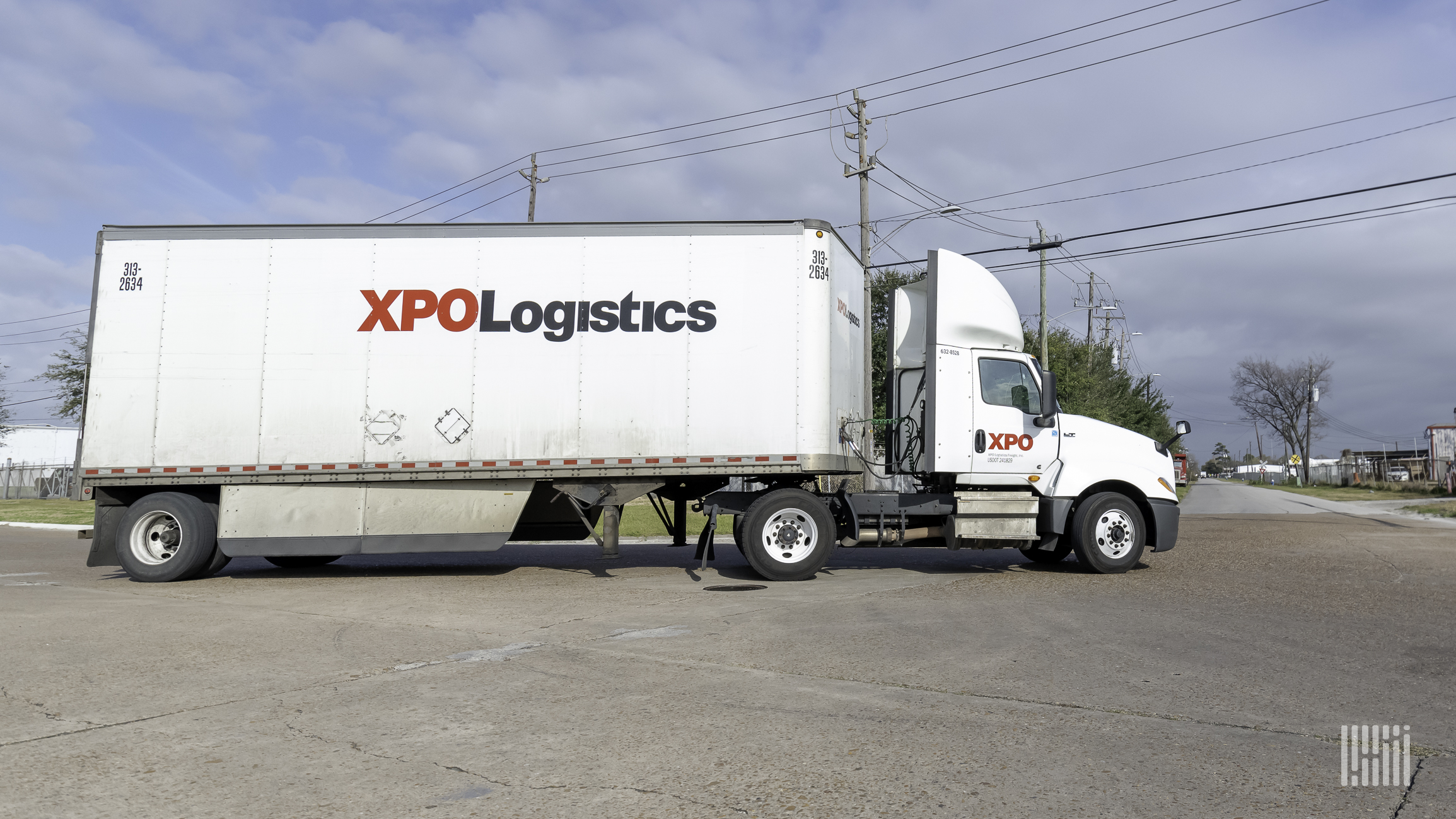 A white tractor-trailer with XPO Logistics written on it