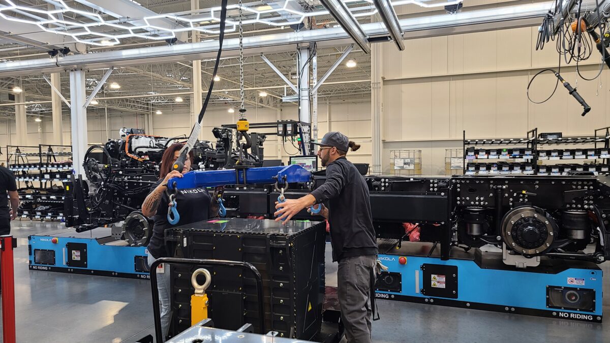 Nikola workers with battery pack