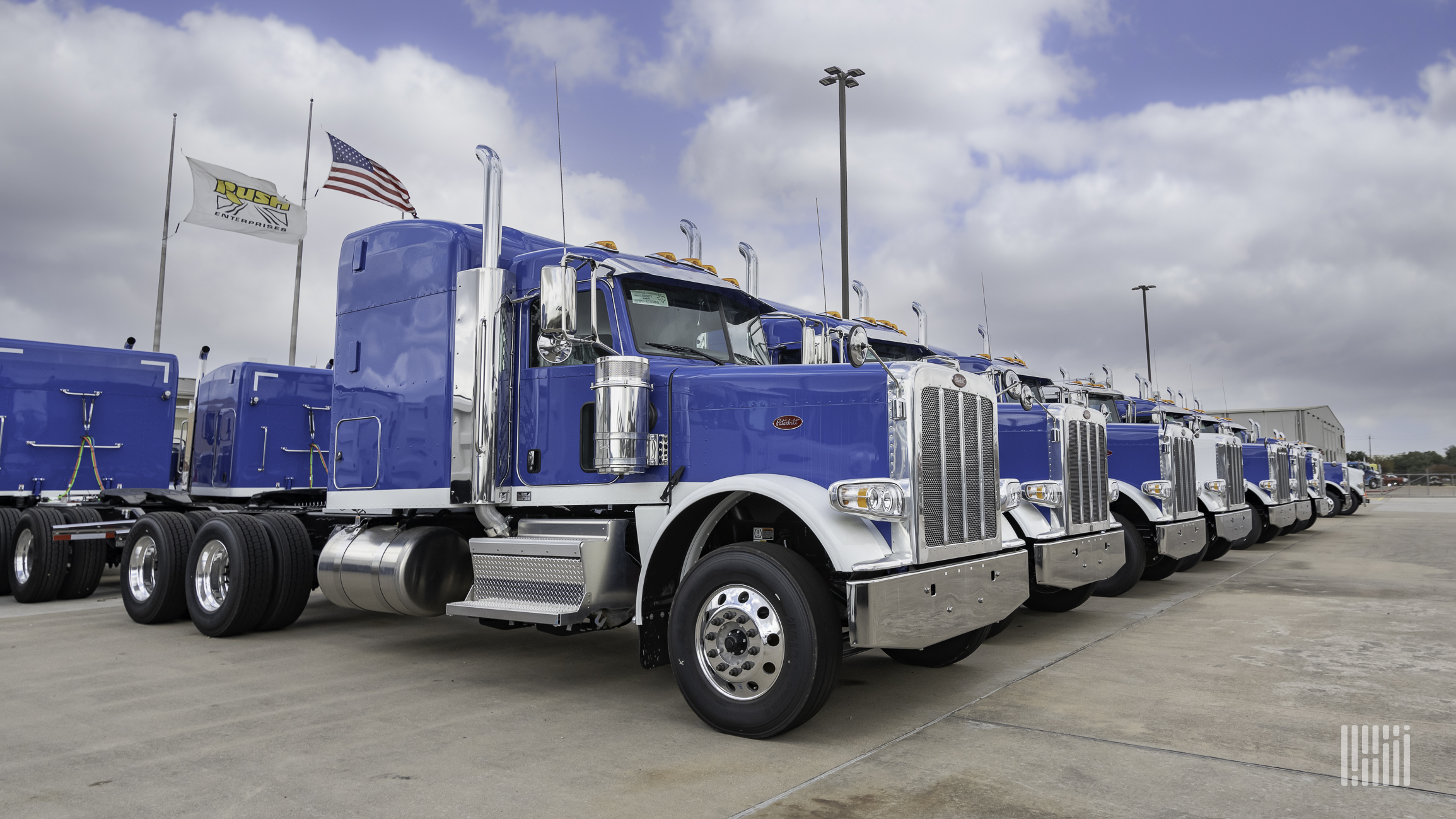 Row of blue Peterbilt Class 8 trucks at dealership