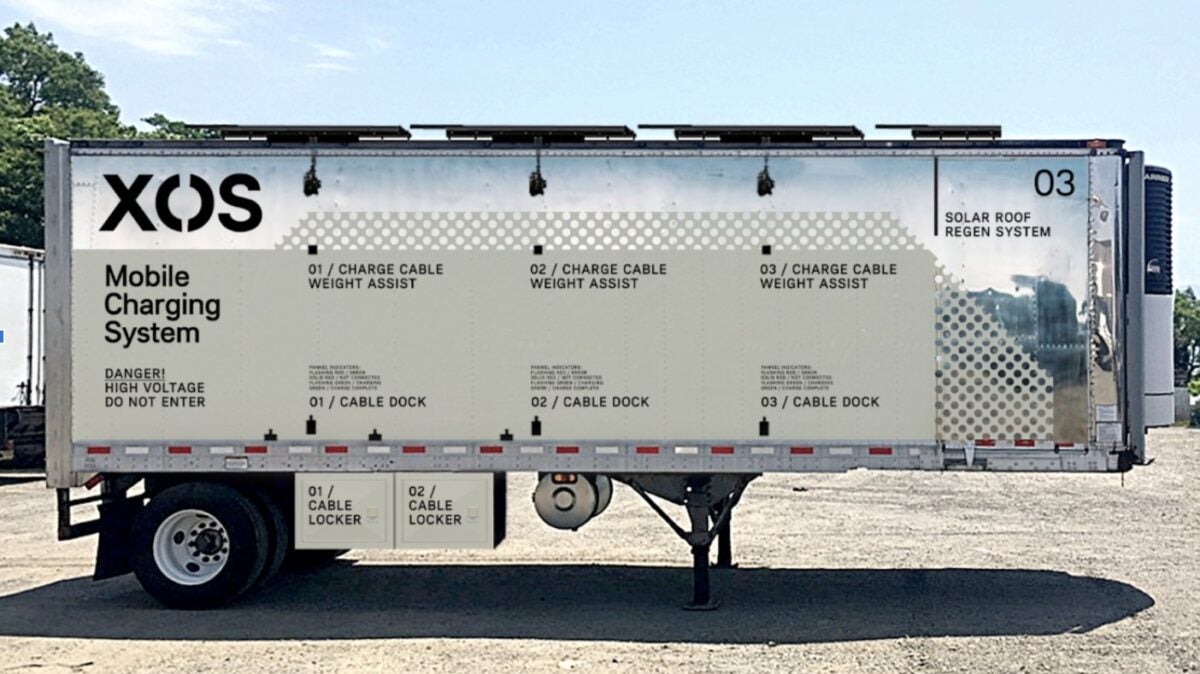 An Xos silver mobile power station in a parking lot.