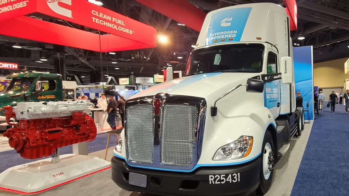 A white and blue Kenworth T680 fuel cell truck at the Cummins Inc. display at the Advanced Clean Transportation Expo.