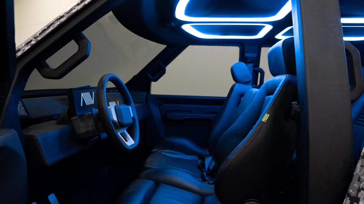 Blue and white lighting illuminate the interior of the Atlis XT electric work truck prototype.