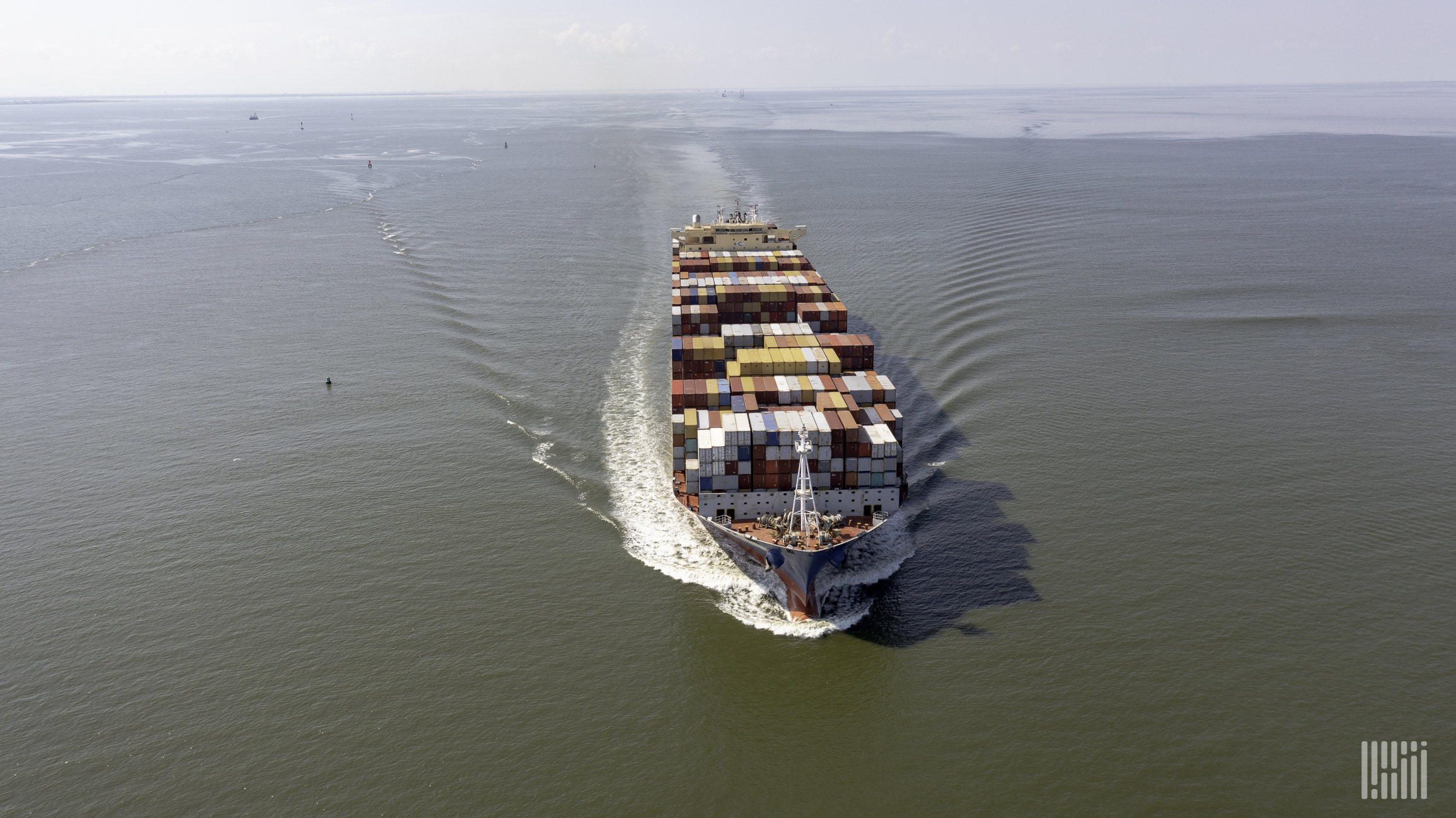 An aerial view of a large container ship on the water