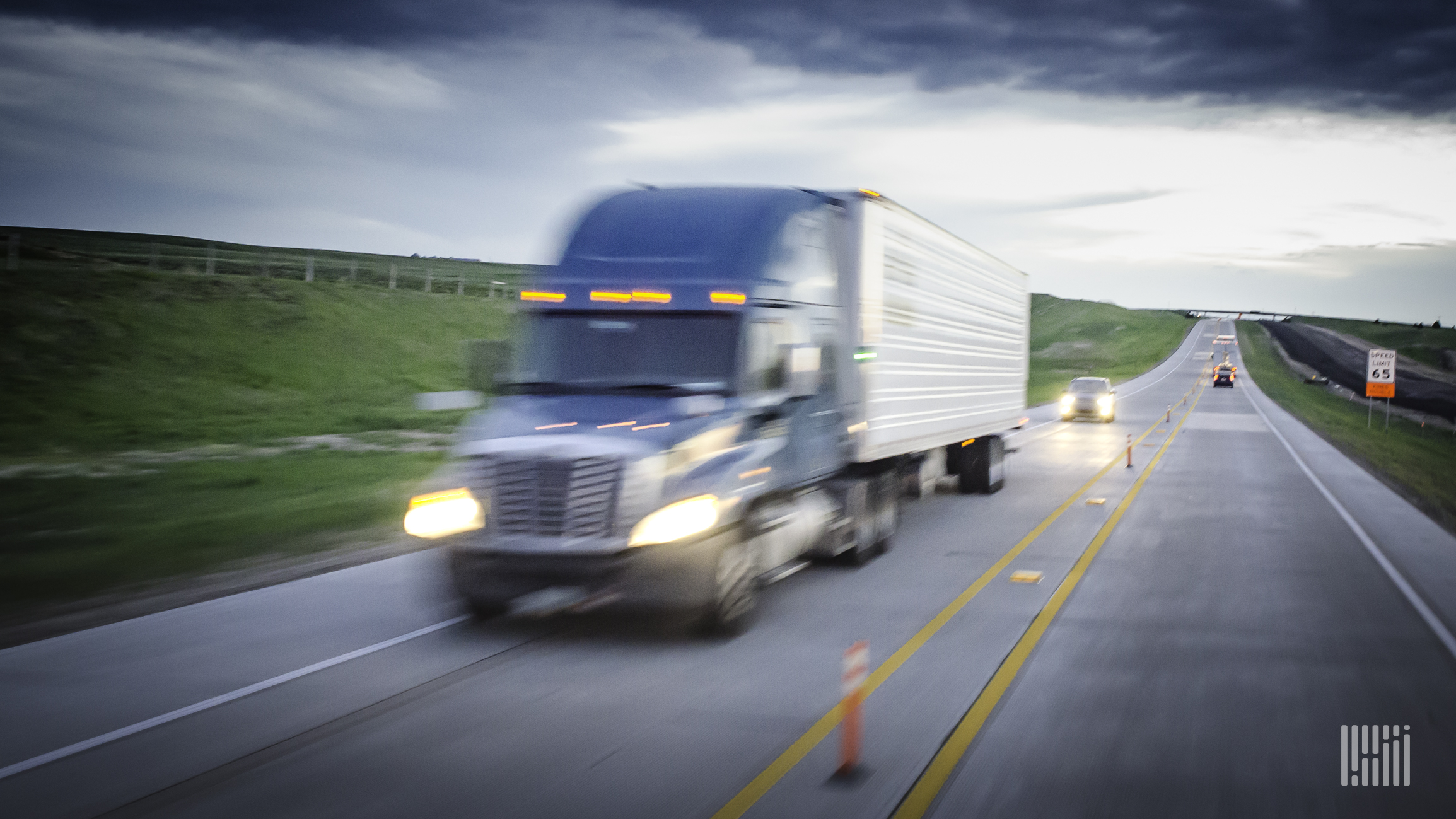 Truck in motion on the highway to illustrate a speed limit for heavy trucks.