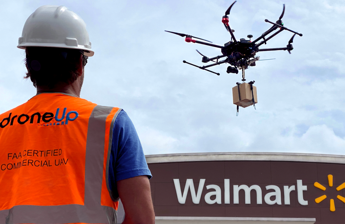 Worker watches drone fly over Walmart store