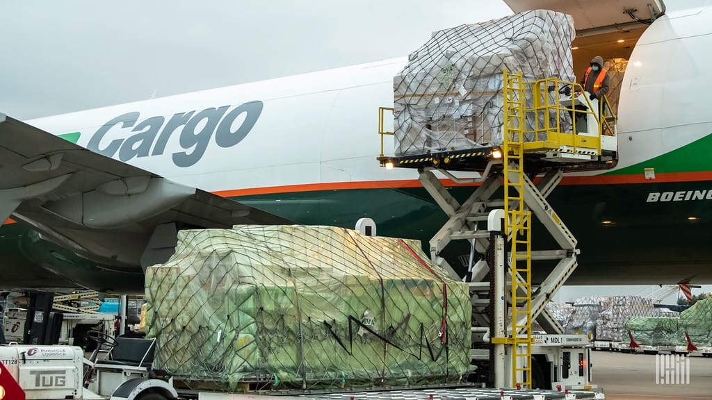 An airplane with the word cargo written on it is loaded.