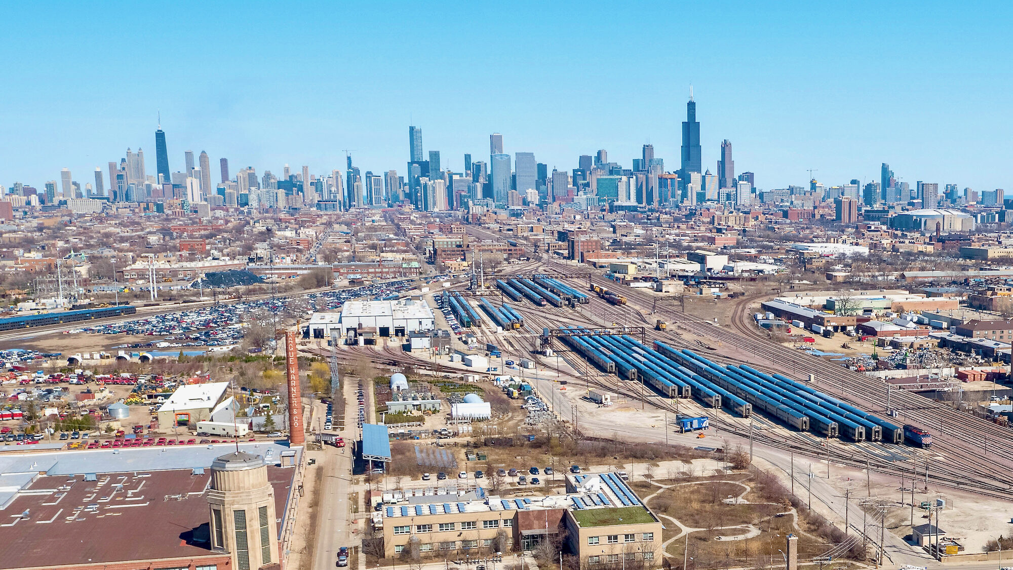 An aerial view of the Chicago skyline with industrial real estate in the foreground.