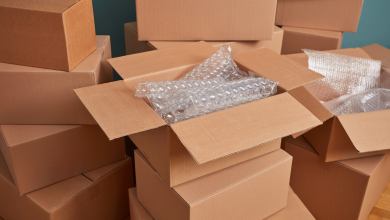 Several shipping boxes are stacked up with bubble wrap packaging inside.