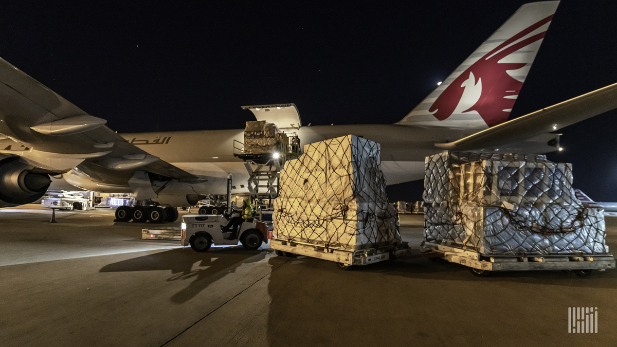 Night loading of cargo on a Qatar Airways jet.