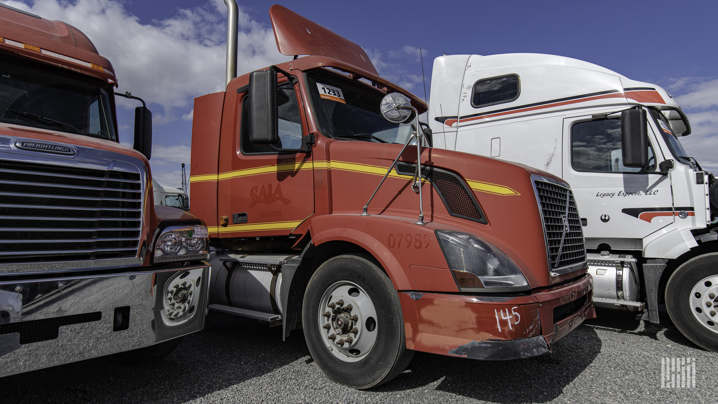 three used trucks at a Ritchie Bros. auction in Houston