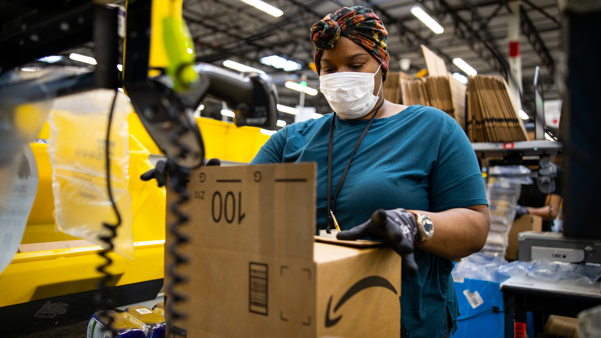 Amazon fulfillment center worker and robot