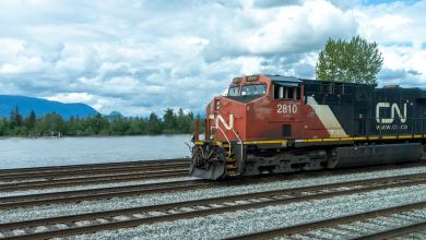 A CN train is operating next to a lake.