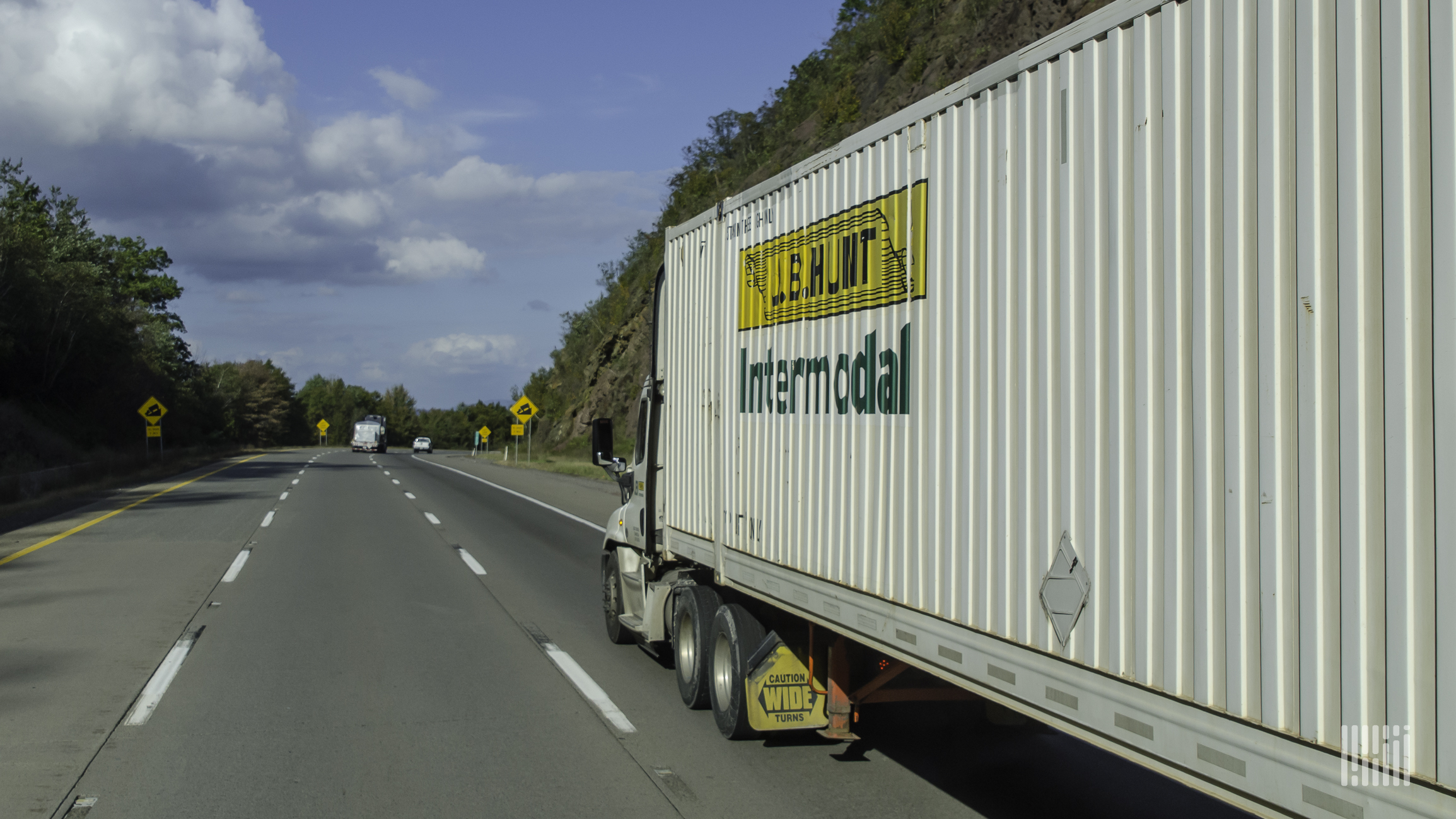 A tractor hauling a J.B. Hunt intermodal trailer