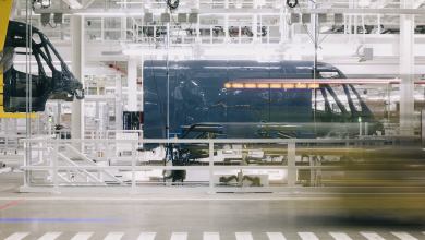 Blue Rivian van on assembly line