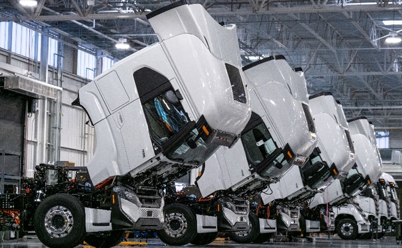 Row of Nikola Tree trucks with hoods open