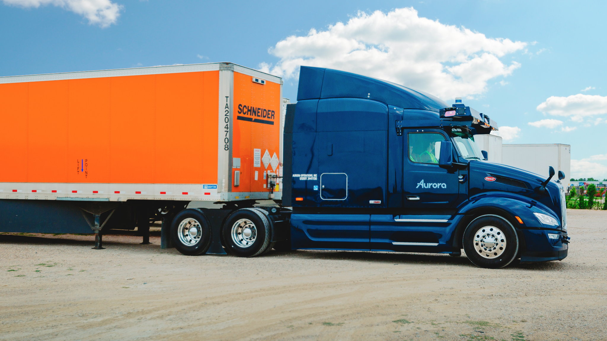 Peterbilt 579 hauls orange Schneider trailer