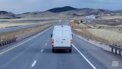 White delivery van driving on highway