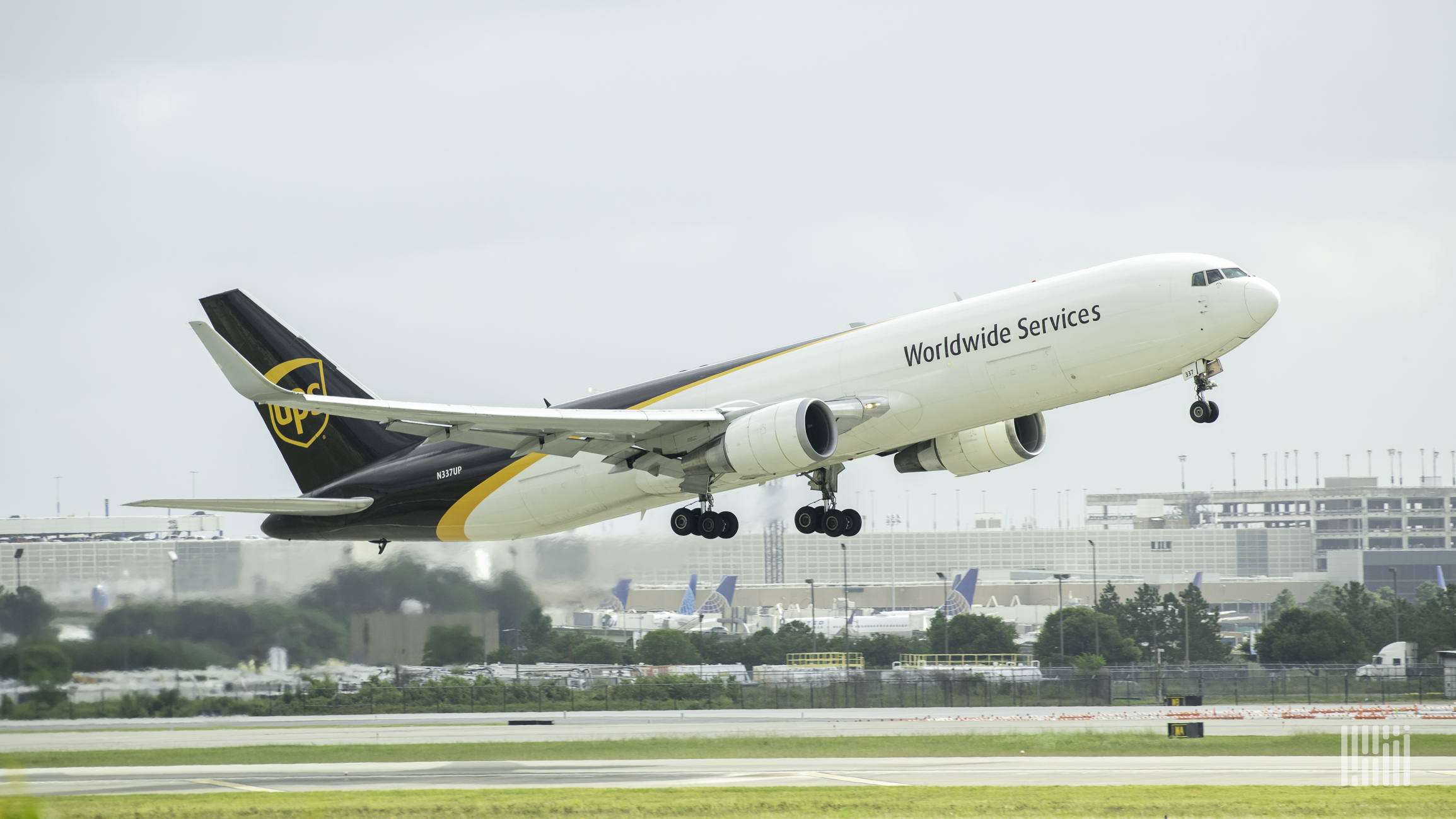 A UPS jet with brown-white paint scheme lifts of runway.