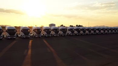 Row of Nikola Tre battery-electric trucks in shadow