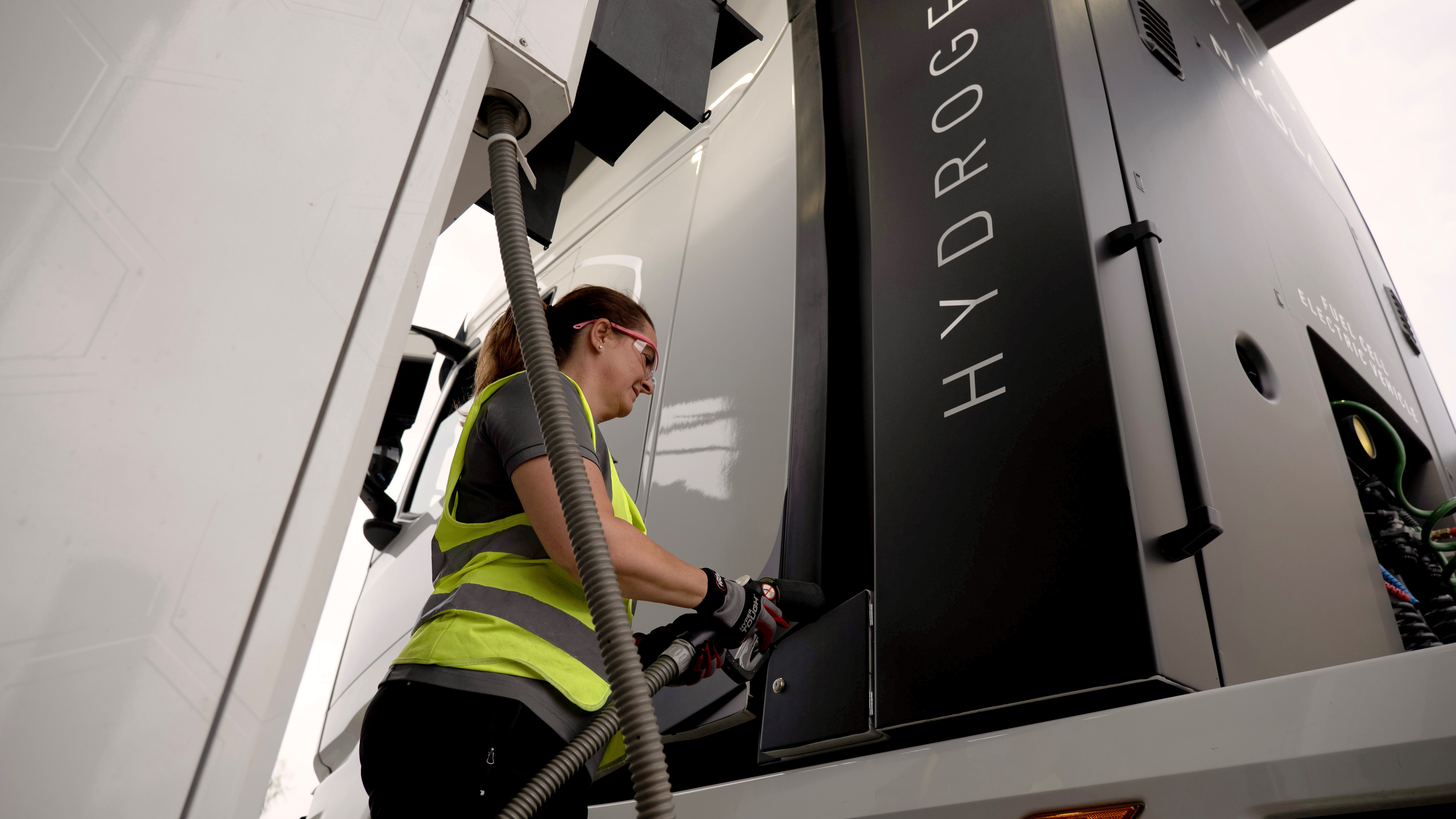 Woman filling up truck at hydrogen fueling station