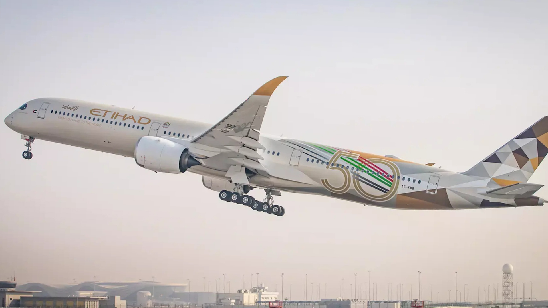A colorful Etihad Airways jetliner takes off from Abu Dhabi airport.