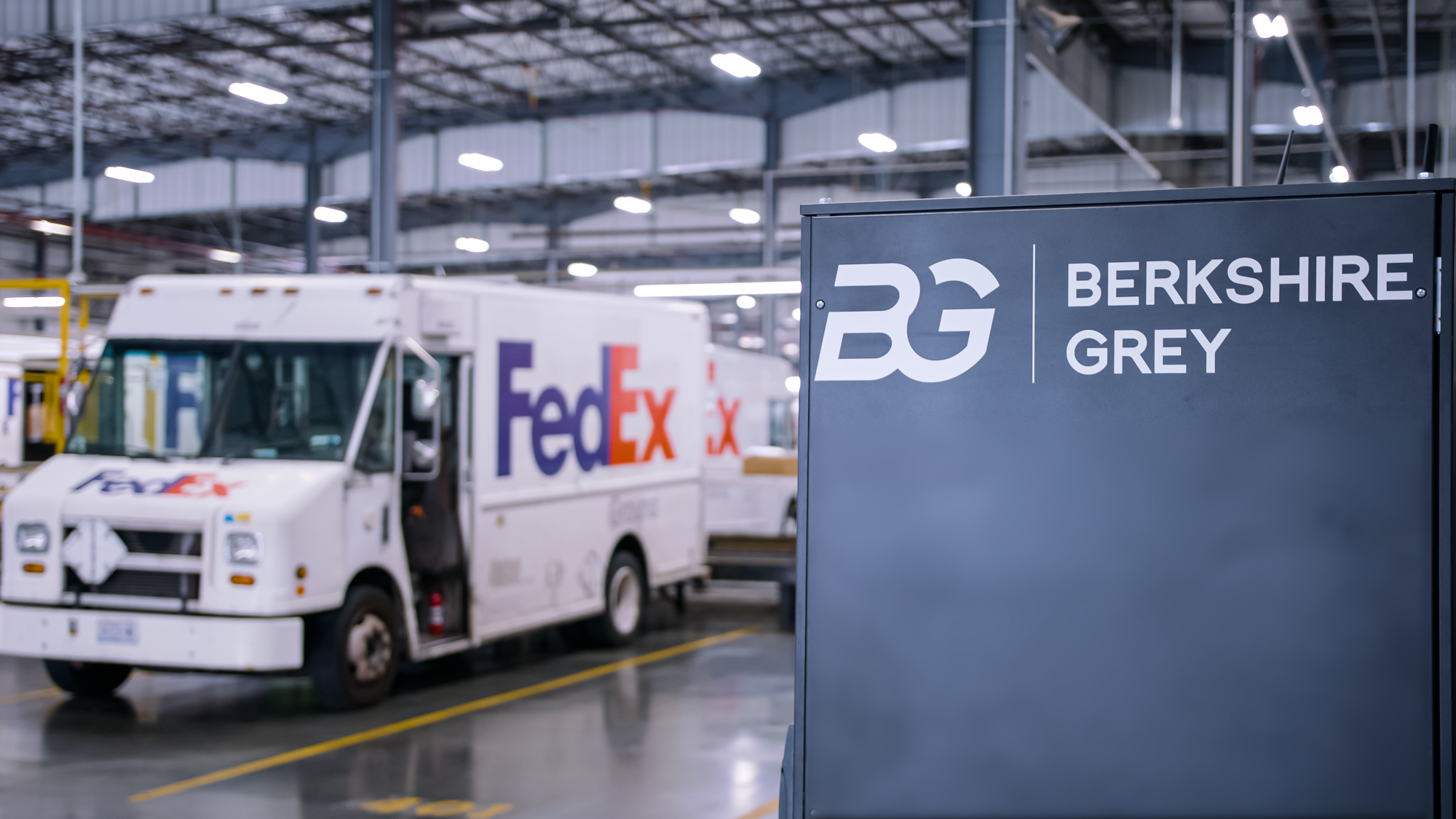FedEx delivery van next to Berkshire Grey robotics sortation center