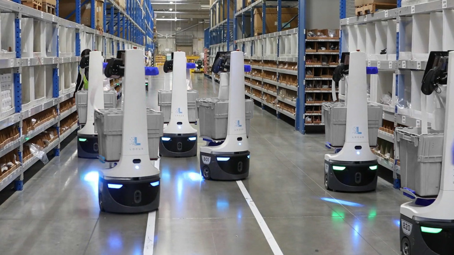 Robots carry totes in warehouse