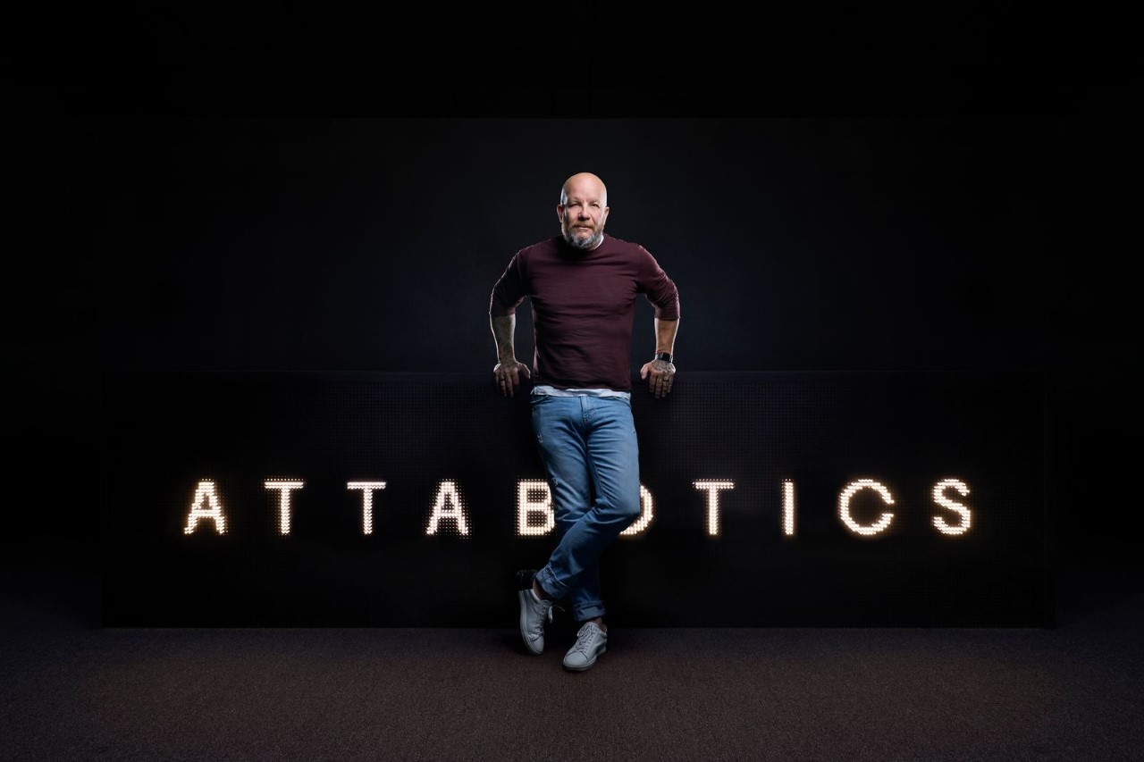 Attabotics CEO Scott Gravelle standing in front of company logo