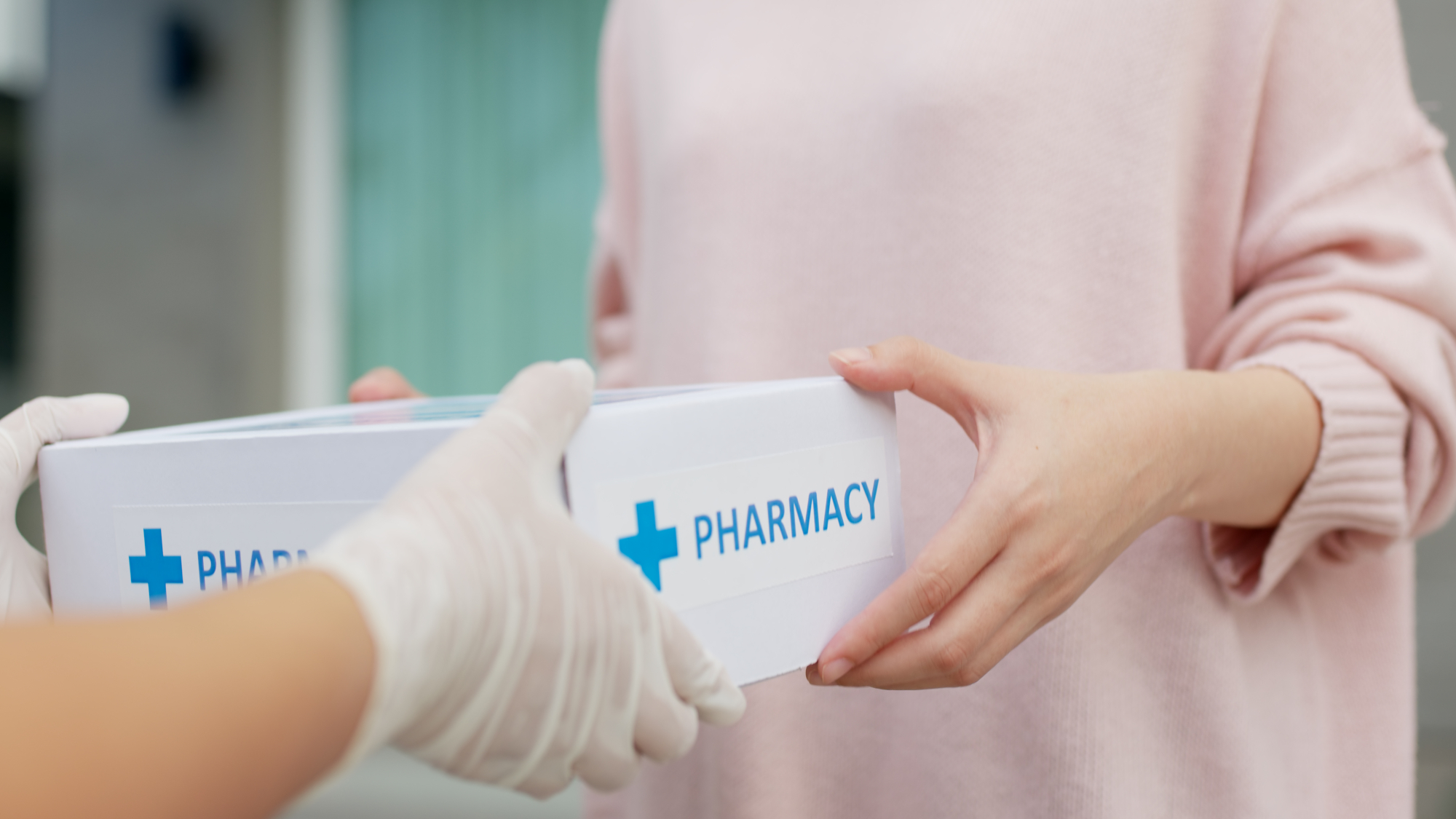 delivery driver hands over box of medicine