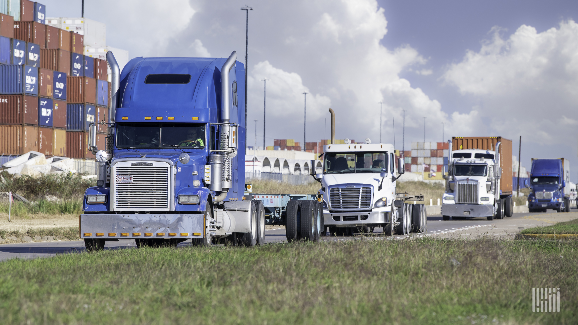 Multiple drayage trucks at a port