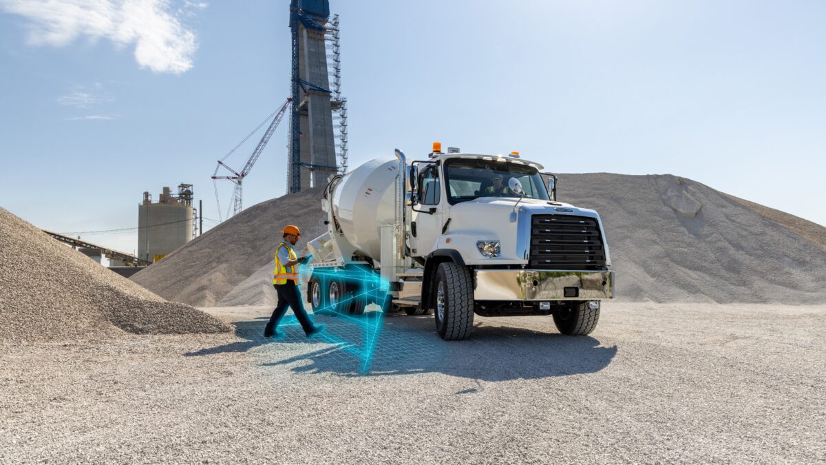 Sideguard Assist illustrated to show worker is seen by the truck's side radar.