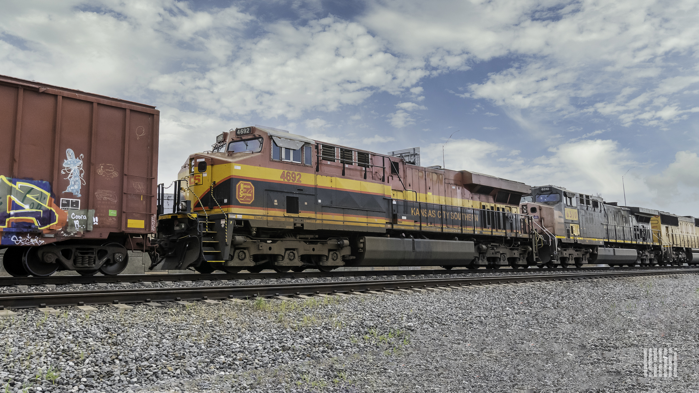 A Kansas City Southern locomotive sits on railroad track.